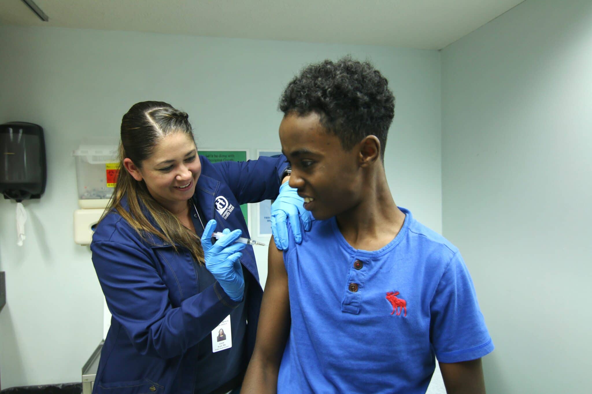 Teenage boy receiving flu shot by DPHD nurse